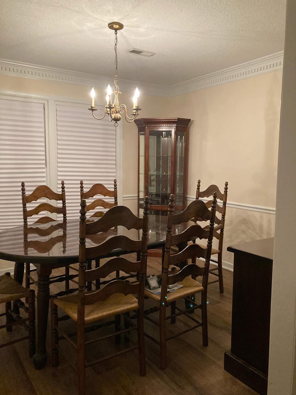 The same dining room after painting in warm neutral tones with the border removed and trim refreshed.