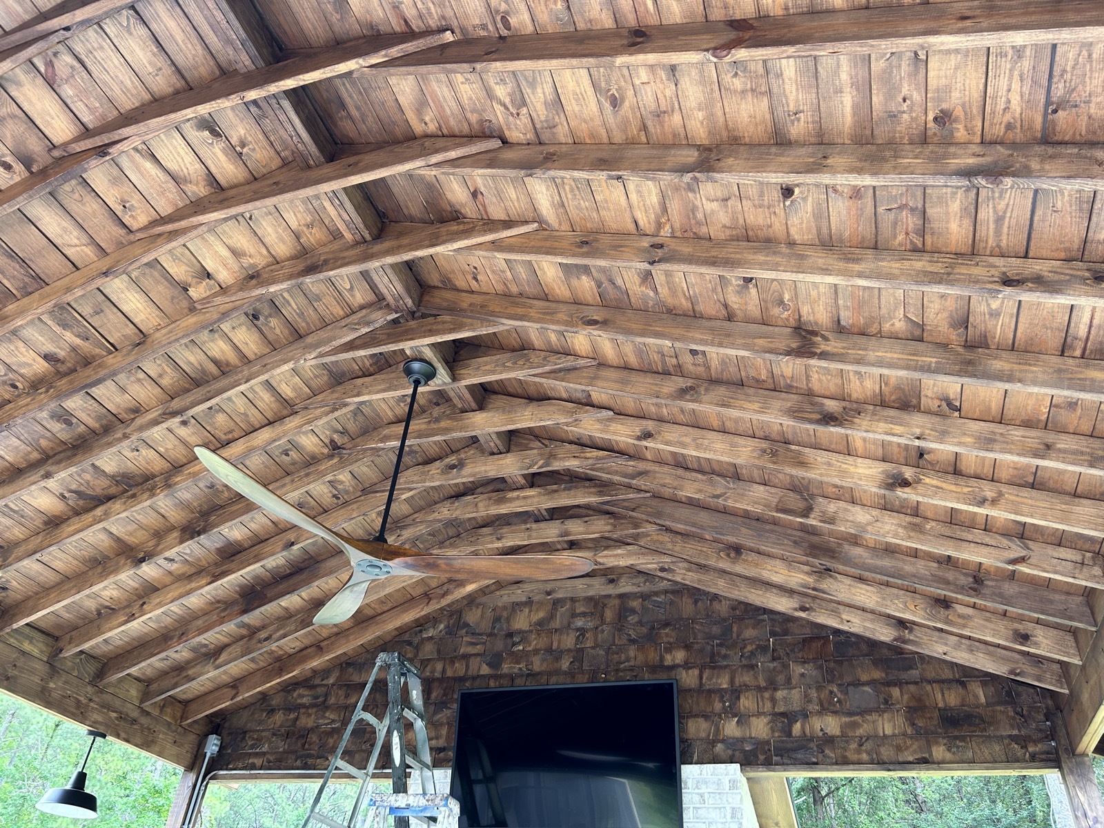 The same vaulted porch ceiling after being stained a darker warm brown.
