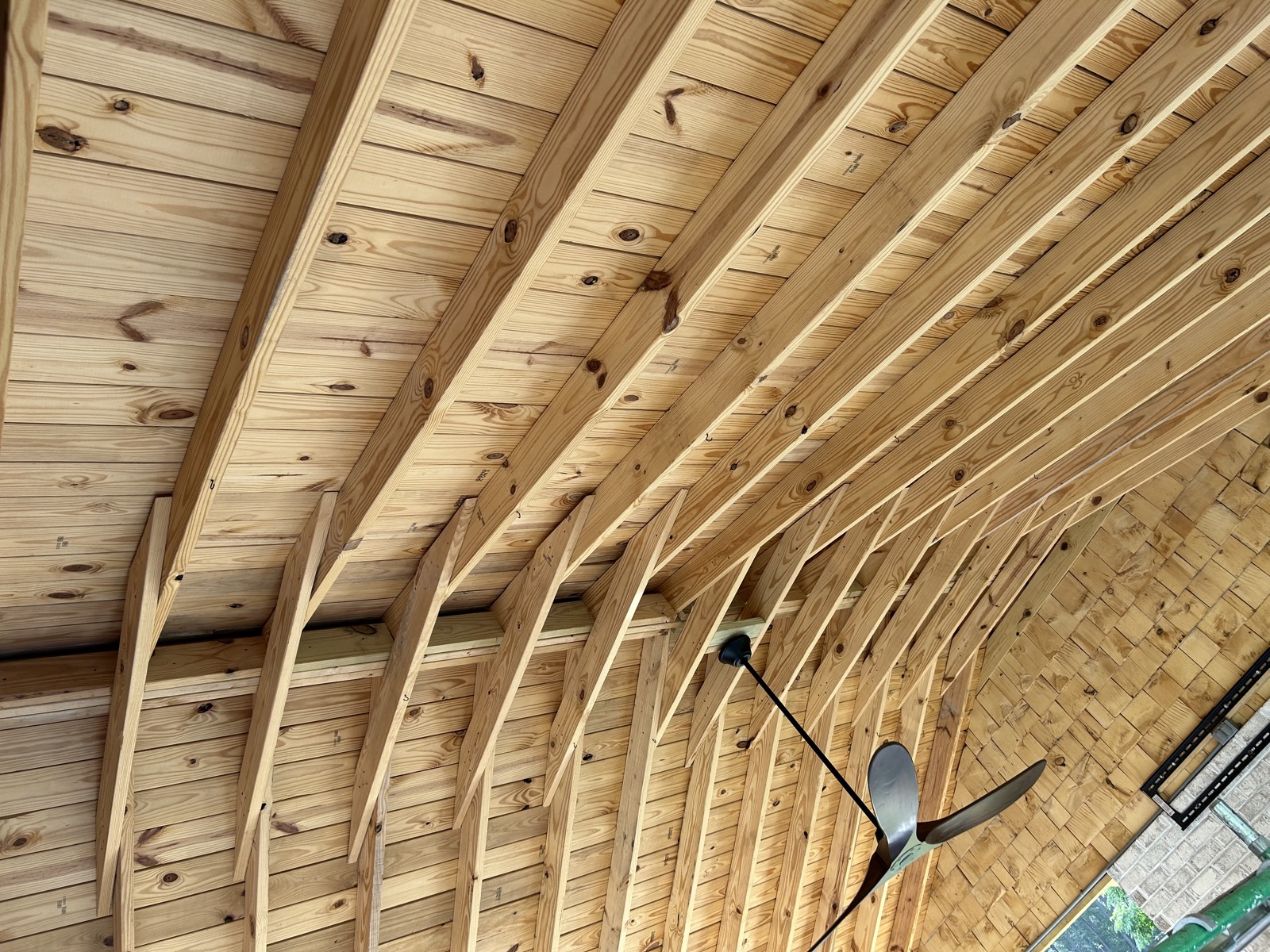 Vaulted porch ceiling in unfinished natural wood before stain and finish.