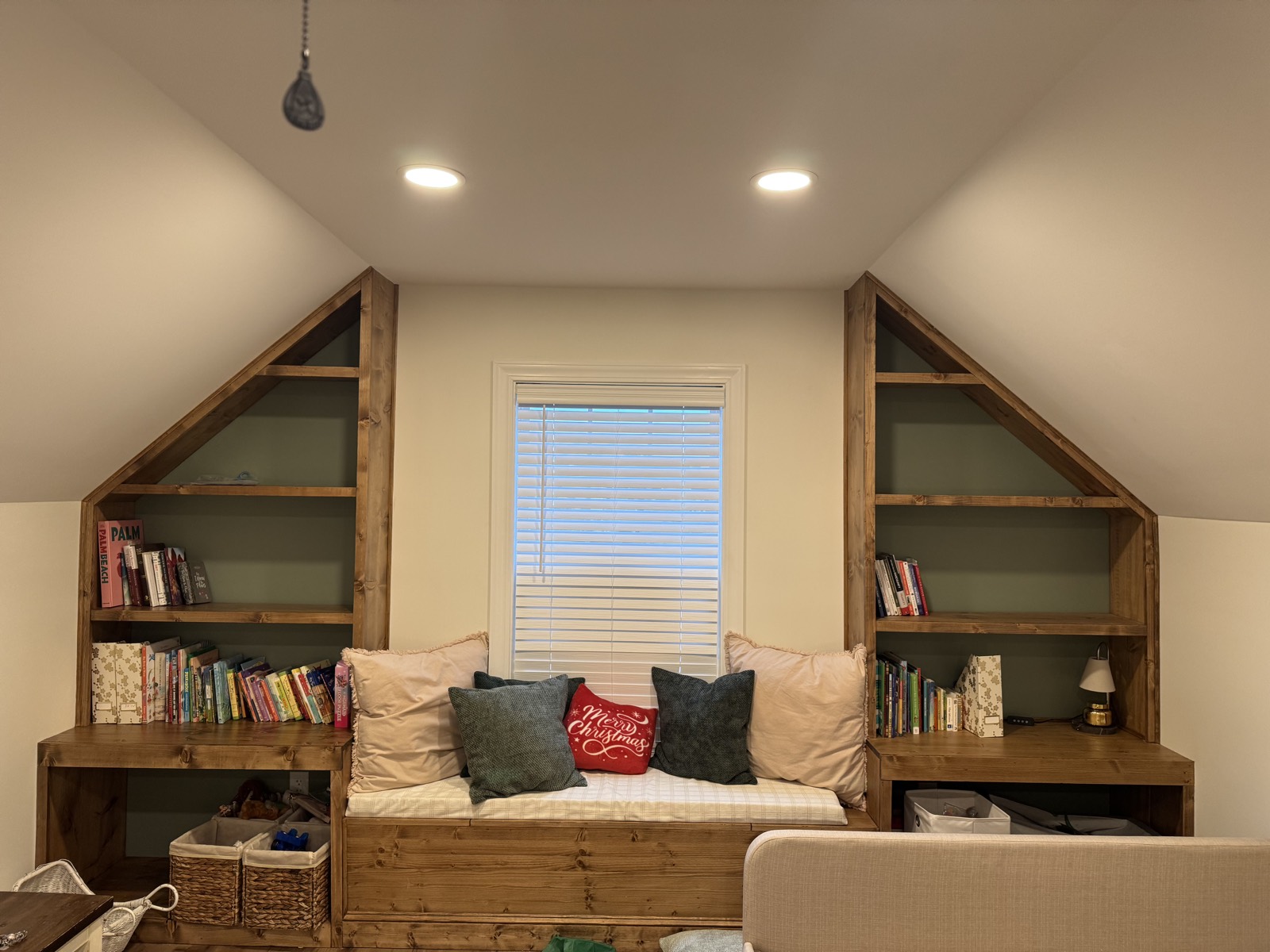 The same upstairs wall after adding a custom built-in window seat and wood shelving.