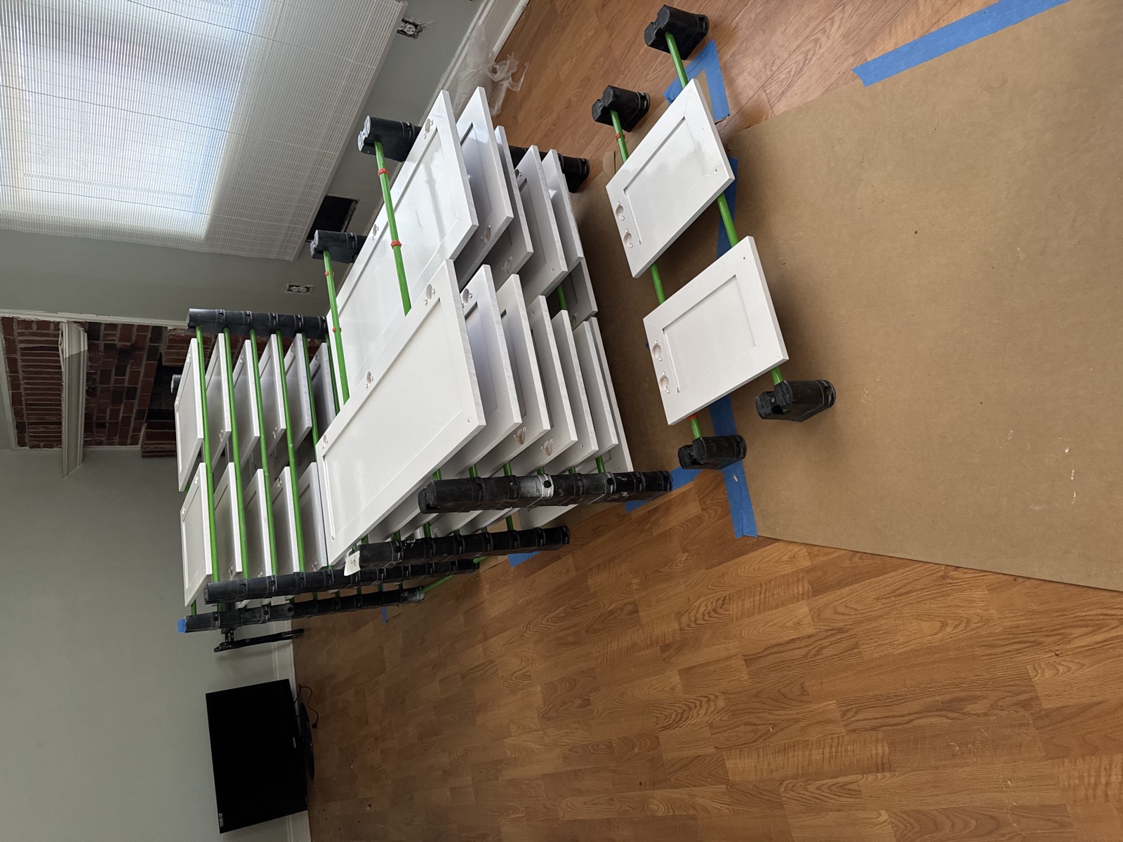 Cabinet doors and drawer fronts drying after being prepped and refinished.